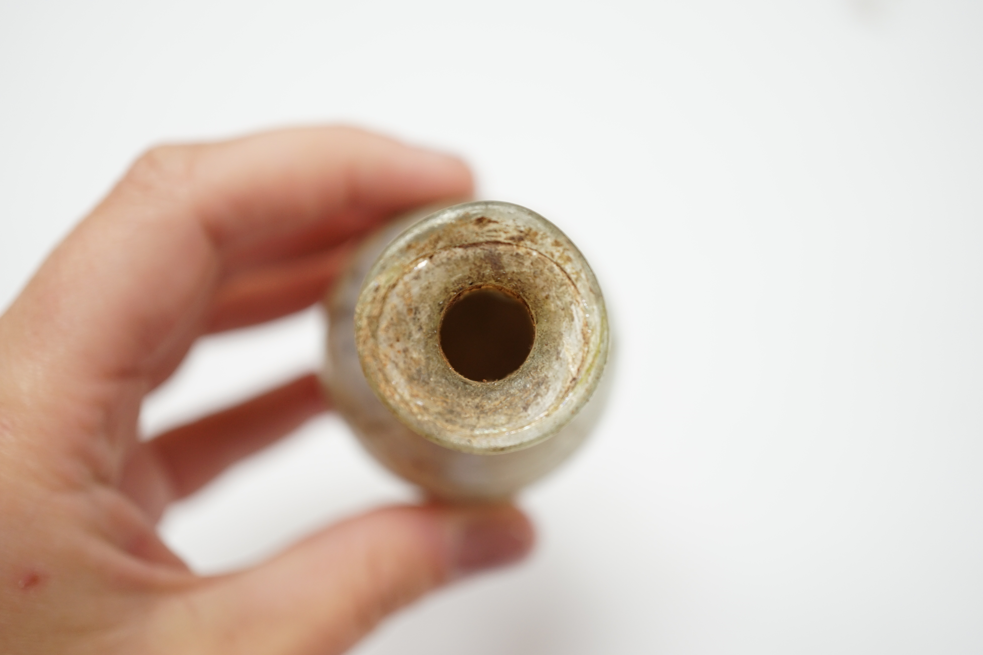 A Roman glass unguentarium, with trailed decoration, 14cm